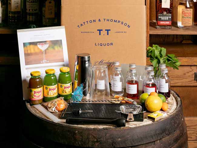 Virtual cocktail kit contents laid out on top of a barrel