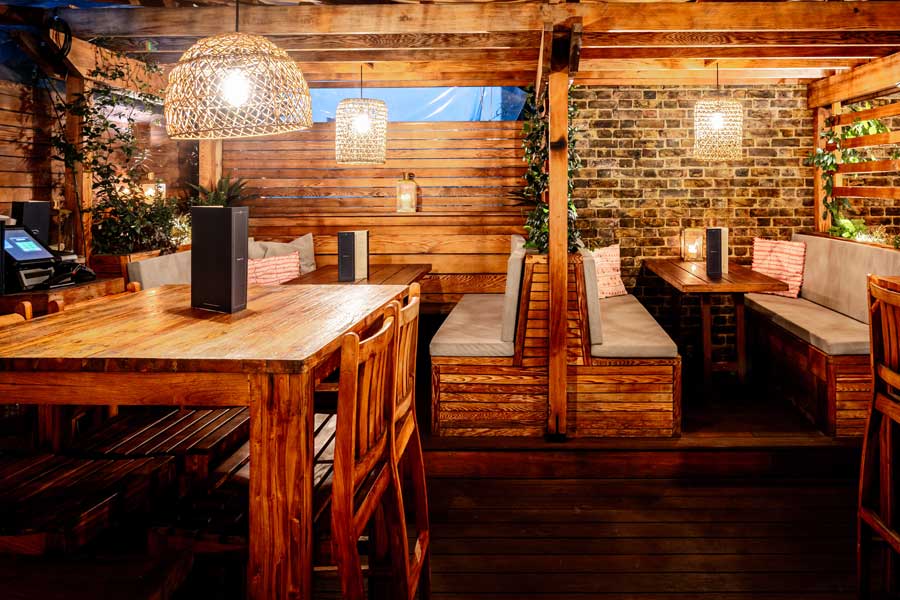 View of tables and chairs at private dining on rootop restaurant in East London